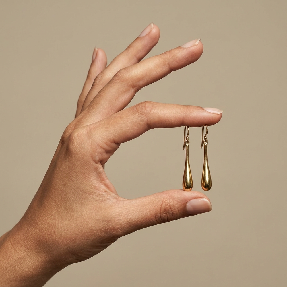 Liquid drop brass earrings – worn on ear by Ozel