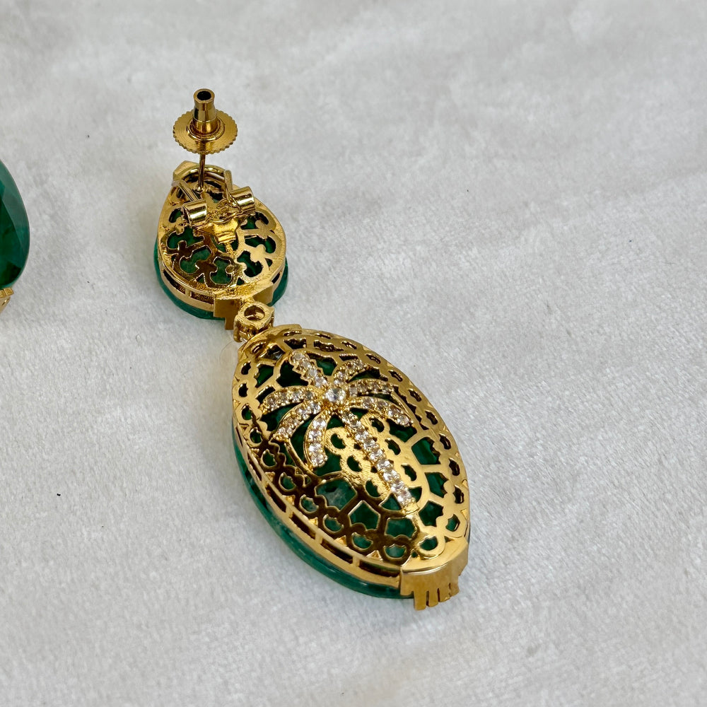Royale emerald drop earrings – worn on ear styled by Ozel