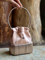 Cord bucket bag with 18kt gold and diamonds charm