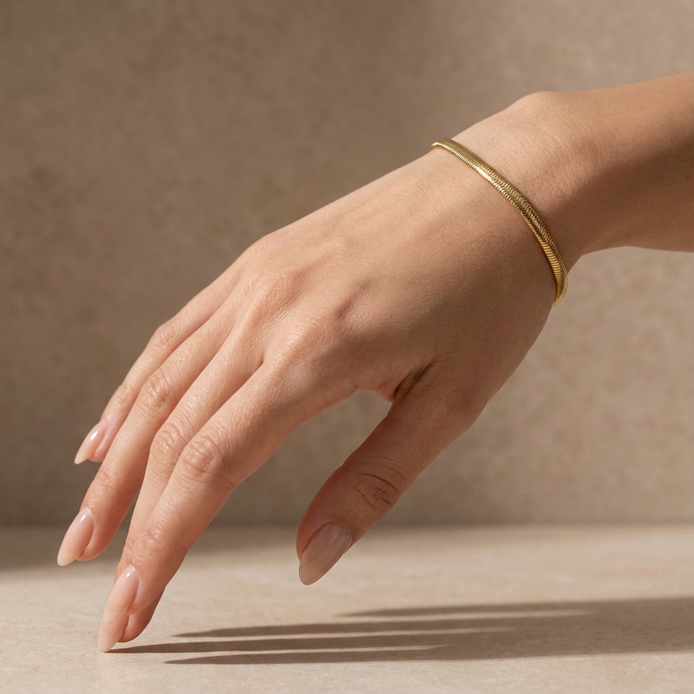 Minimal gold everyday bracelet – worn on wrist by Ozel