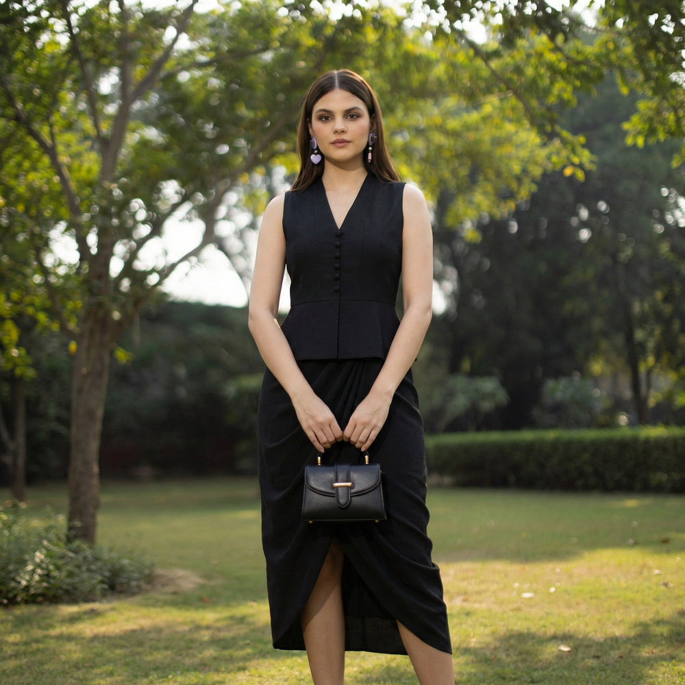 Detail of sculpted peplum top tailoring — Ozel